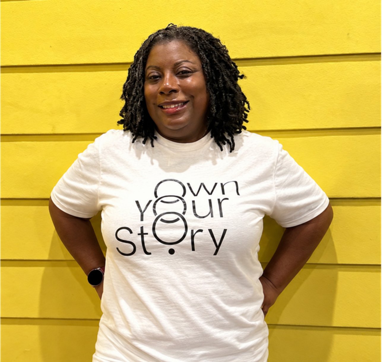 TiffMichelle wearing an Own Your Story shirt